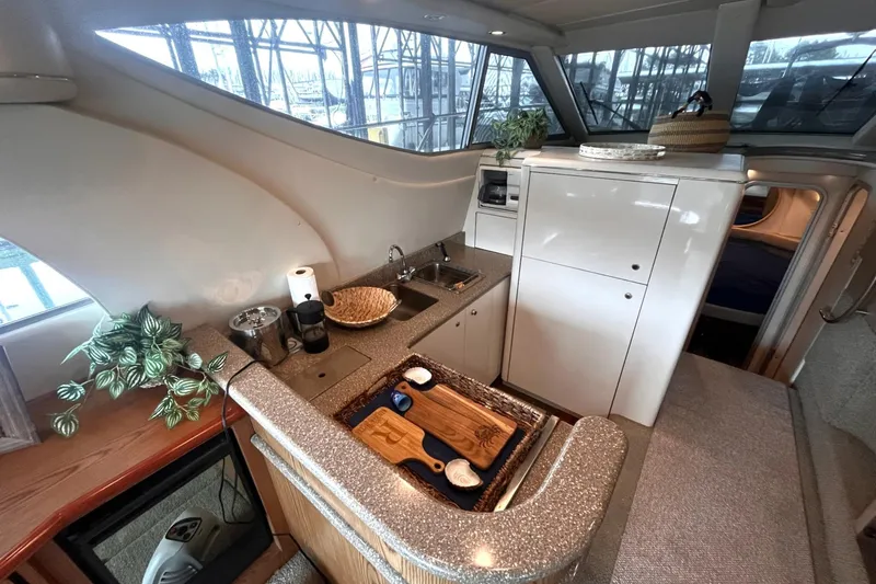 Slide: The Image of Luxurious 1999 Maxum 4100 SCB yacht interior with modern kitchen amenities. - 10