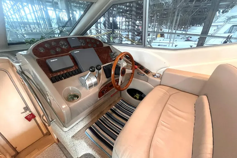 Slide: The Image of 1999 Maxum 4100 SCB yacht helm with wood steering wheel and modern controls. - 16