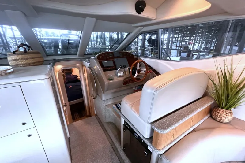 Slide: The Image of Interior of 1999 Maxum 4100 SCB yacht with helm, seating, and cabin entrance. - 17