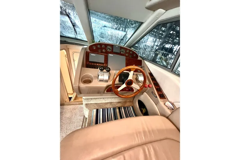 Slide: The Image of 1999 Maxum 4100 SCB yacht helm with wooden steering wheel and modern controls. - 18
