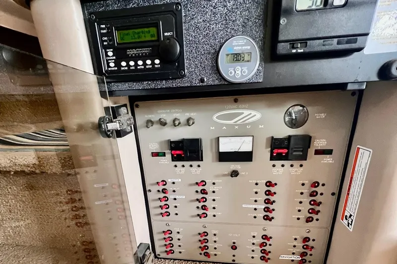 Slide: The Image of Electrical control panel of a 1999 Maxum 4100 SCB boat, featuring various switches and gauges. - 19