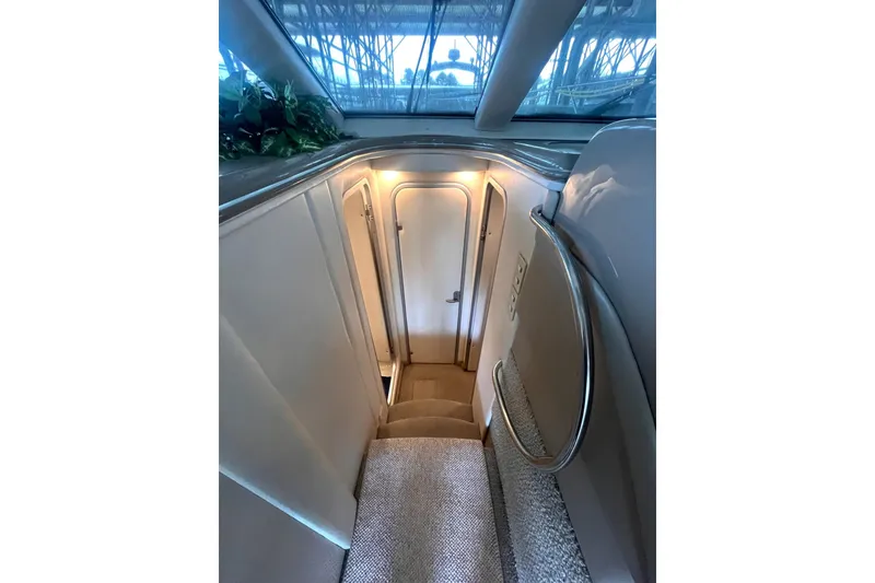 Slide: The Image of Interior stairs of 1999 Maxum 4100 SCB yacht with elegant lighting and handrail. - 20