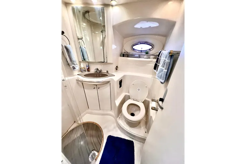 Slide: The Image of Luxurious bathroom in 1999 Maxum 4100 SCB yacht with modern fixtures and porthole window. - 21