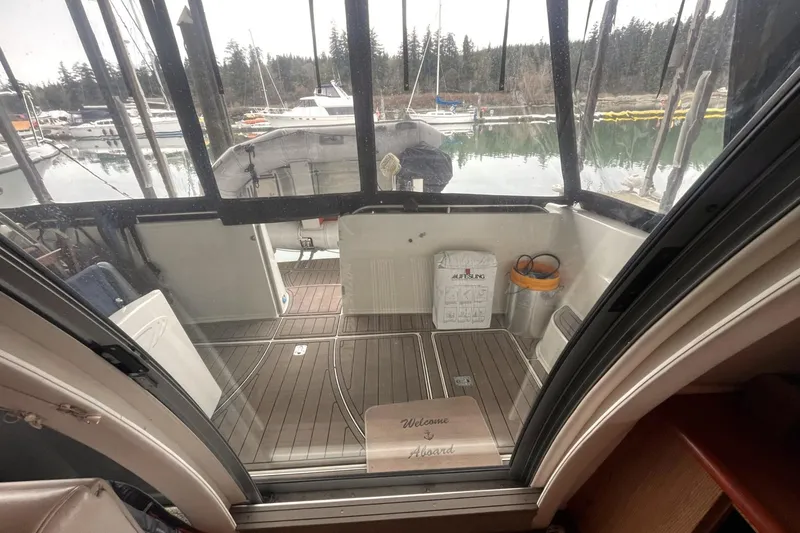 Slide: The Image of 1999 Maxum 4100 SCB yacht interior with wooden deck, docked at marina. - 27