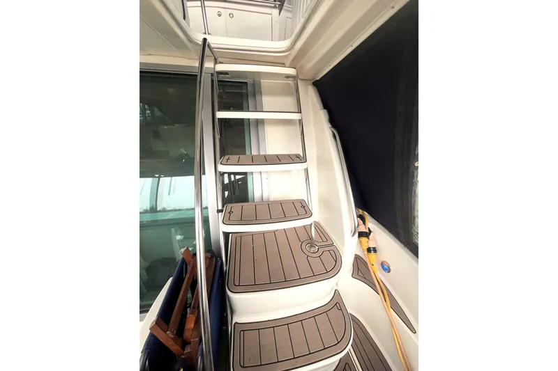 Slide: The Image of Staircase on 1999 Maxum 4100 SCB yacht with wooden steps and metal railing. - 30