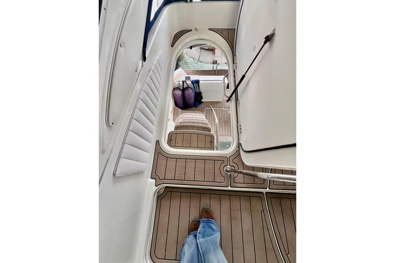 Slide: The Image of 1999 Maxum 4100 SCB yacht interior with wood flooring and seating area. - 31