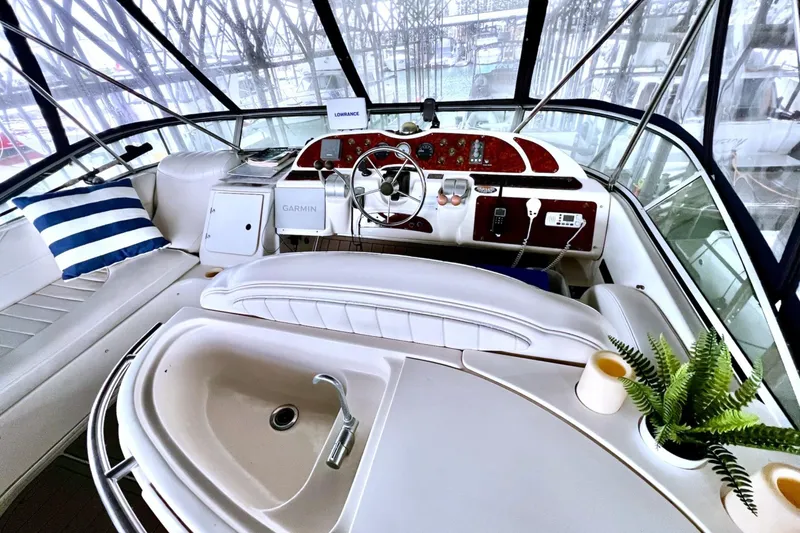 Slide: The Image of Interior of a 1999 Maxum 4100 SCB yacht with helm, seating, and decor. - 34