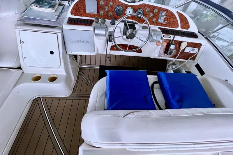 Slide: The Image of 1999 Maxum 4100 SCB boat cockpit with Garmin navigation and wood-accented dashboard. - 35