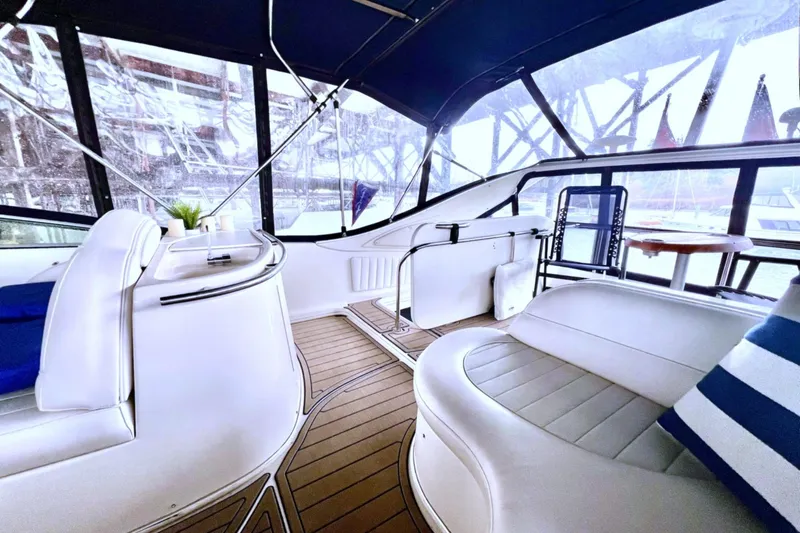 Slide: The Image of Interior of a 1999 Maxum 4100 SCB yacht with white seating and wooden flooring. - 36