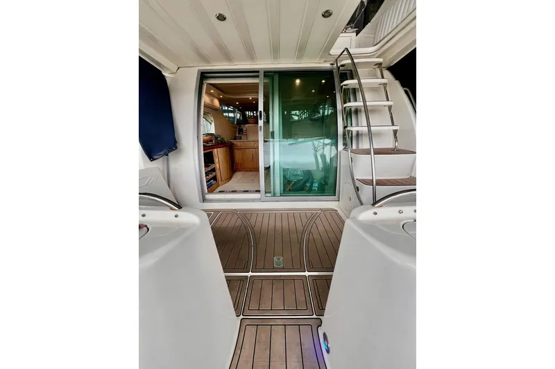 Slide: The Image of 1999 Maxum 4100 SCB yacht interior with wooden flooring and staircase. - 4