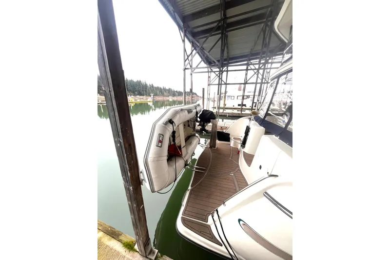 Slide: The Image of 1999 Maxum 4100 SCB yacht docked with inflatable boat on deck. - 40