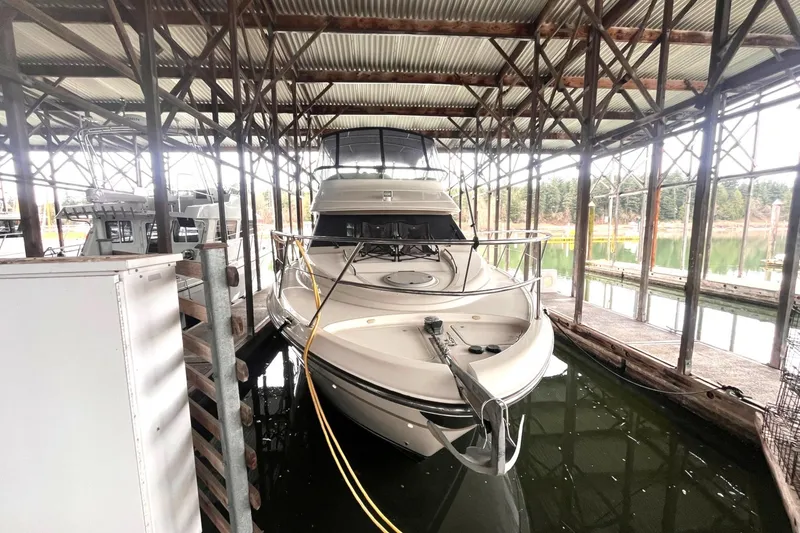 Slide: The Image of 1999 Maxum 4100 SCB yacht docked in a covered marina. - 42