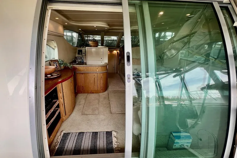 Slide: The Image of Interior view of 1999 Maxum 4100 SCB yacht, featuring elegant wood cabinetry and modern amenities. - 5