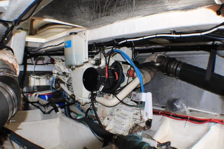 Slide: The Image of Engine room of a 1999 Maxum 4100 SCB boat, showcasing mechanical components and wiring. - 50