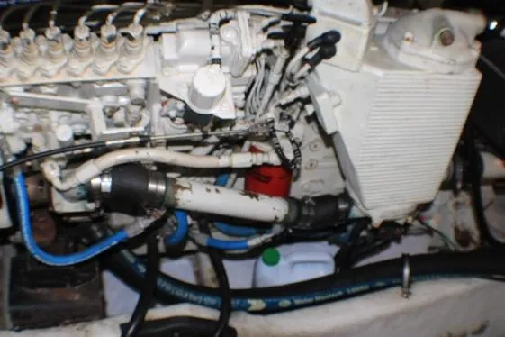Slide: The Image of Engine compartment of a 1999 Maxum 4100 SCB boat, showing hoses and components. - 51