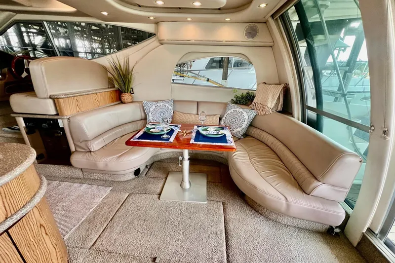Slide: The Image of Luxurious interior of 1999 Maxum 4100 SCB yacht with elegant dining area and plush seating. - 6
