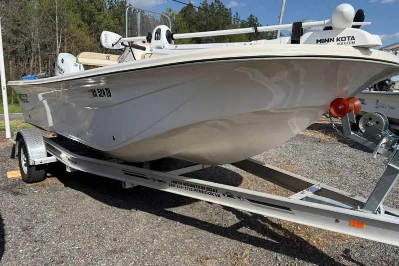 Slide: The Image of 2023 Carolina Skiff 19 LS boat on trailer, featuring Minn Kota Maxxum motor. - 14