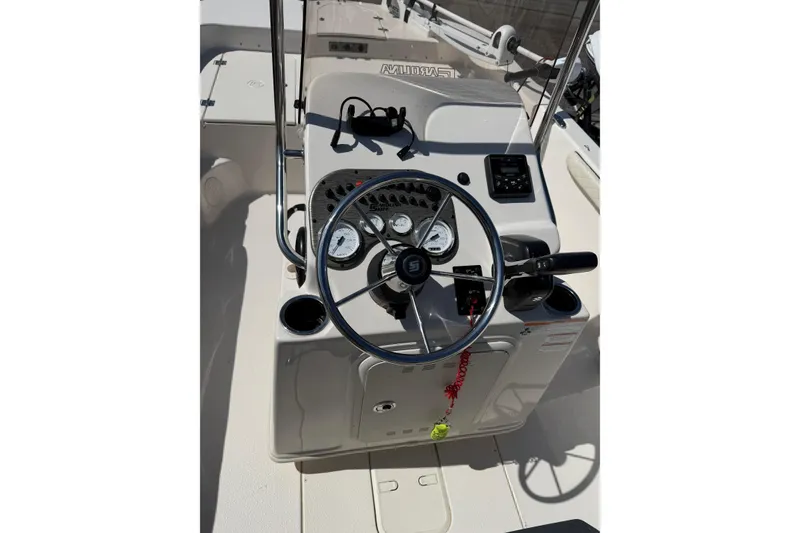 Slide: The Image of 2023 Carolina Skiff 19 LS boat console with steering wheel and gauges. - 16