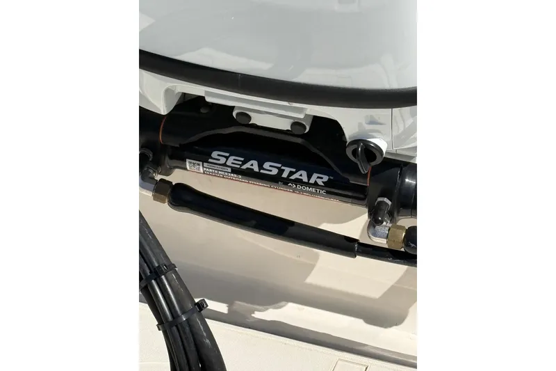 Slide: The Image of Close-up of SeaStar hydraulic steering system on 2023 Carolina Skiff 19 LS boat. - 19
