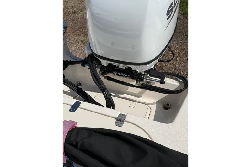 Slide: The Image of 2023 Carolina Skiff 19 LS boat engine detail with SeaStar hydraulic steering. - 20