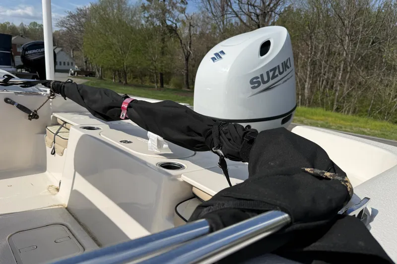 Slide: The Image of 2023 Carolina Skiff 19 LS boat with Suzuki outboard motor, docked outdoors. - 5