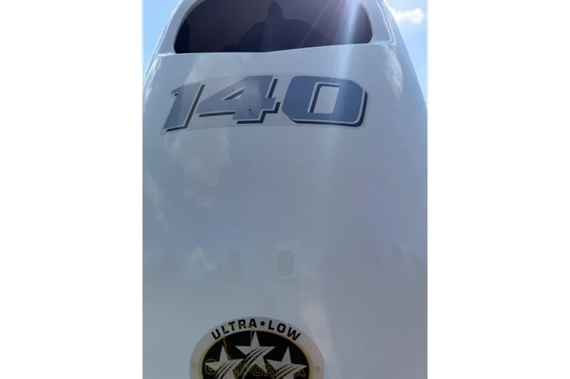 Slide: The Image of Close-up of 2023 Carolina Skiff 19 LS boat engine with '140' and 'Ultra-Low' labels. - 9