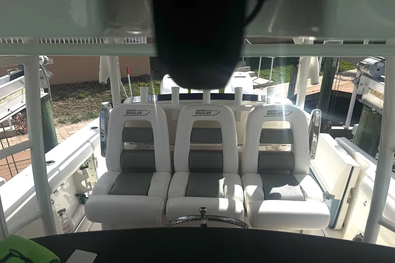 Slide: The Image of 2014 Boston Whaler 350 Outrage boat interior with cushioned seating. - 10