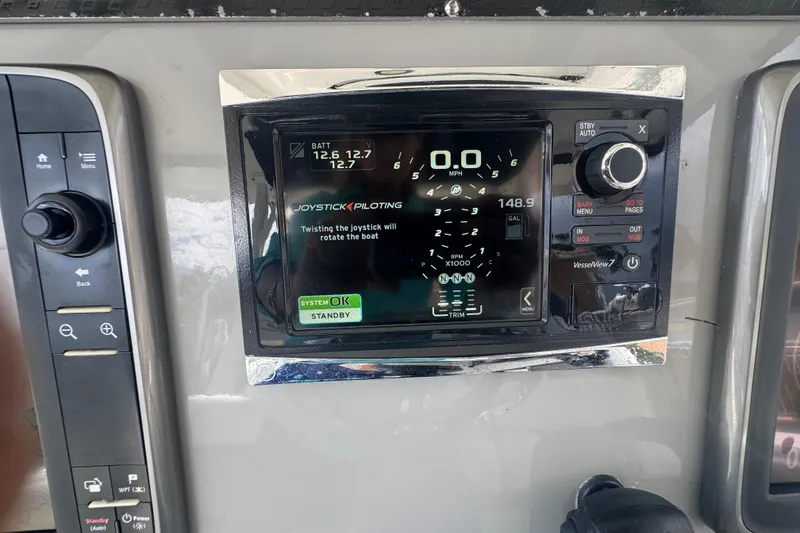 Slide: The Image of Control panel of a 2014 Boston Whaler 350 Outrage boat, featuring joystick piloting system. - 12