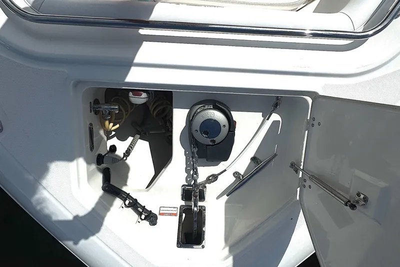 Slide: The Image of Anchor compartment of 2014 Boston Whaler 350 Outrage boat, featuring winch and chain. - 17