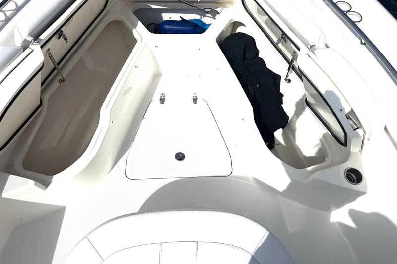 Slide: The Image of 2014 Boston Whaler 350 Outrage boat interior with open storage compartments. - 21