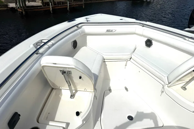 Slide: The Image of 2014 Boston Whaler 350 Outrage boat interior with white seating and speakers.  Also showing the back rest - 22