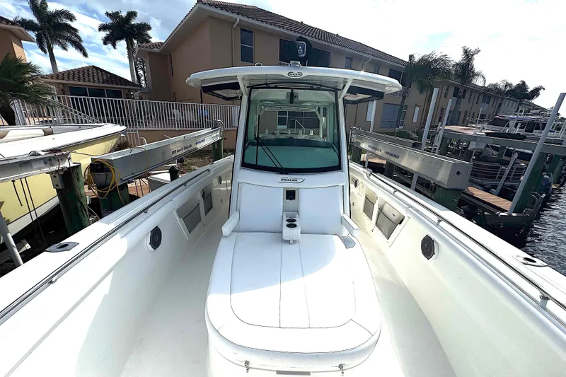 Slide: The Image of 2014 Boston Whaler 350 Outrage boat docked near waterfront homes. - 23