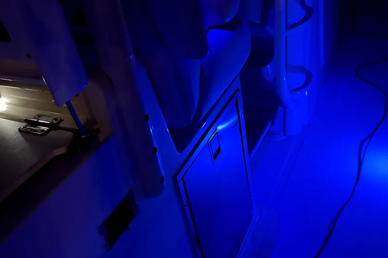 Slide: The Image of 2014 Boston Whaler 350 Outrage interior with blue ambient lighting. - 27