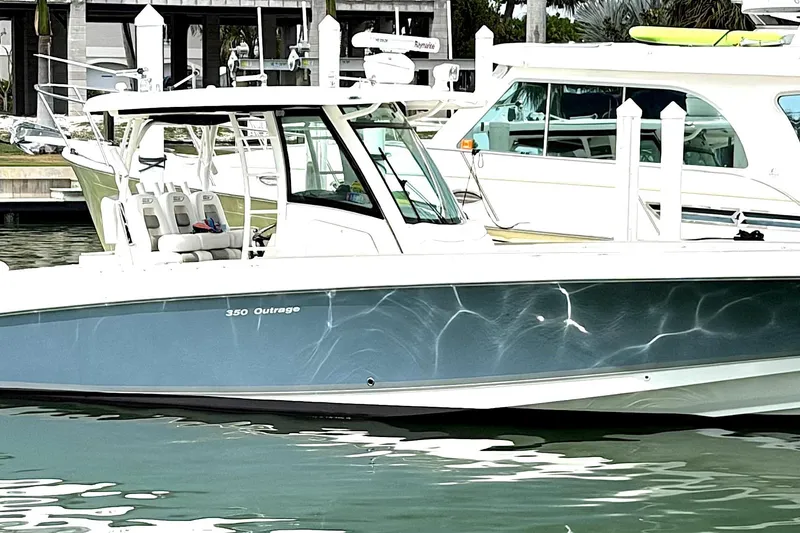 Slide: The Image of 2014 Boston Whaler 350 Outrage boat docked in marina, side view. - 3