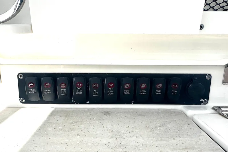 Slide: The Image of Control panel of a 2014 Boston Whaler 350 Outrage boat with labeled switches. - 31