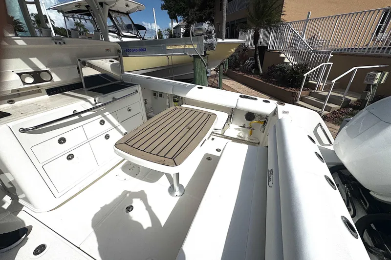 Slide: The Image of 2014 Boston Whaler 350 Outrage boat interior with seating and storage compartments. - 40