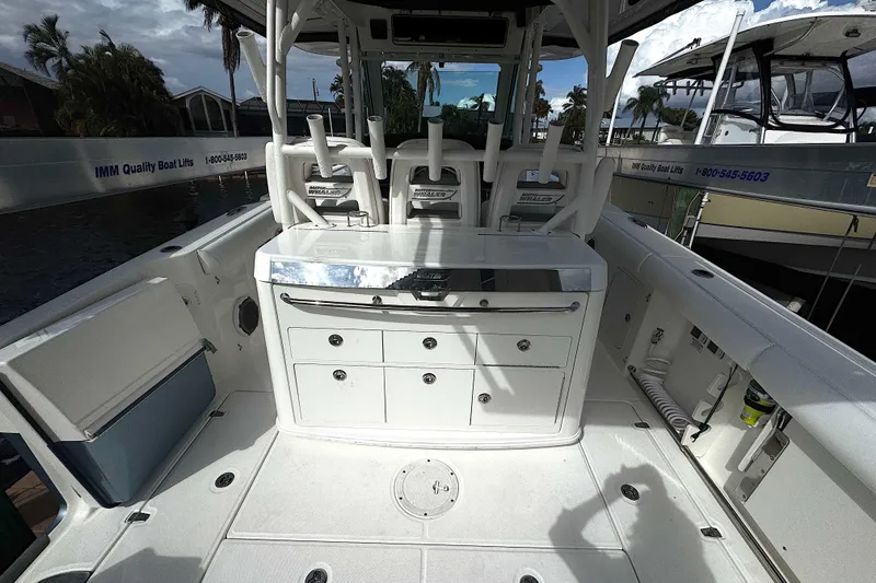 Slide: The Image of 2014 Boston Whaler 350 Outrage boat interior with seating and storage compartments. - 43