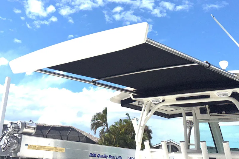 Slide: The Image of 2014 Boston Whaler 350 Outrage boat with extended sunshade. - 45