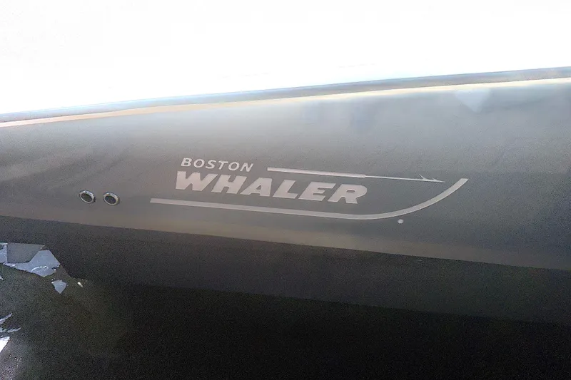 Slide: The Image of 2014 Boston Whaler 350 Outrage boat logo on hull. - 47