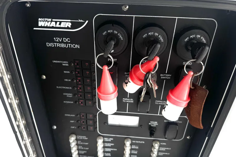 Slide: The Image of Control panel of a 2014 Boston Whaler 350 Outrage boat with keys and switches. - 48