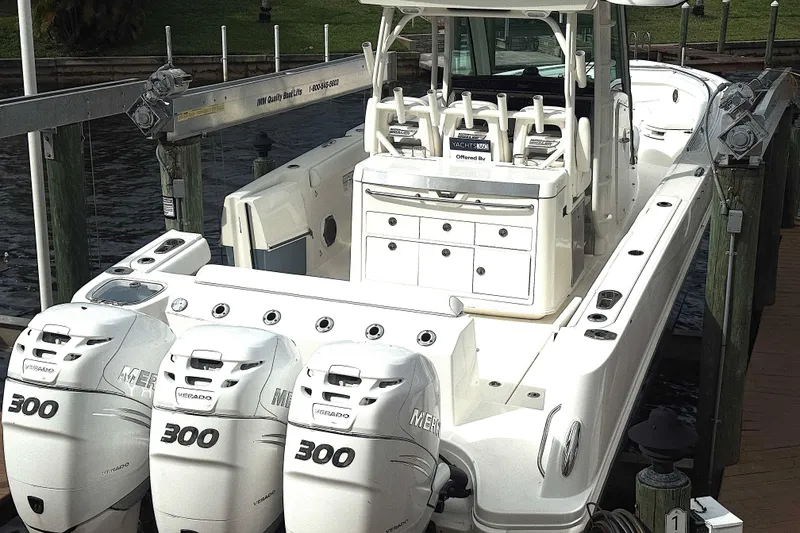 Slide: The Image of 2014 Boston Whaler 350 Outrage with triple Mercury engines docked behind owners home. - 5