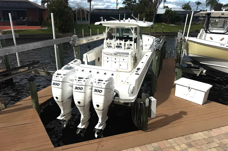 Slide: The Image of 2014 Boston Whaler 350 Outrage boat docked with triple Mercury 300 engines. - 51