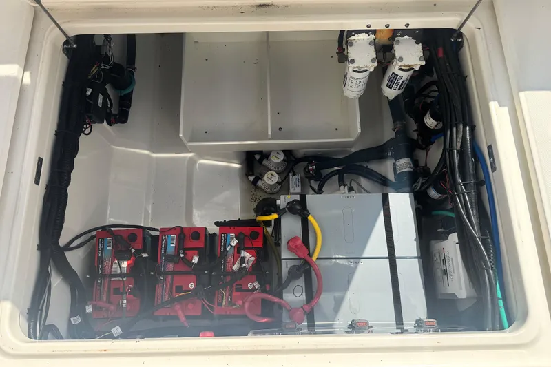 Slide: The Image of 2014 Boston Whaler 350 Outrage engine compartment with batteries and wiring. - 56
