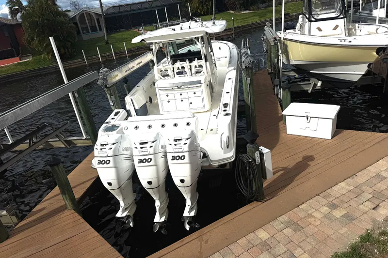 Slide: The Image of 2014 Boston Whaler 350 Outrage docked with triple Mercury 300 engines. - 6