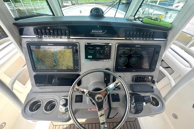 Slide: The Image of Boston Whaler 350 Outrage 2014 helm with navigation screens and controls. - 8