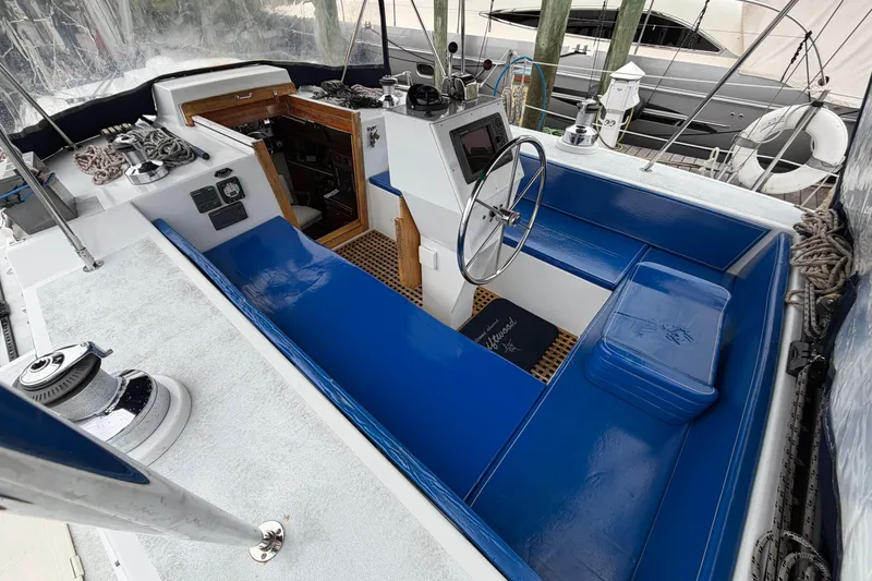 Slide: The Image of Cockpit of 2011 Custom Build 50' Ketch, featuring blue seating and steering wheel. - 18