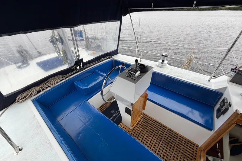 Slide: The Image of Cockpit of 2011 Custom Build 50' Ketch, featuring blue seating and steering wheel. - 19
