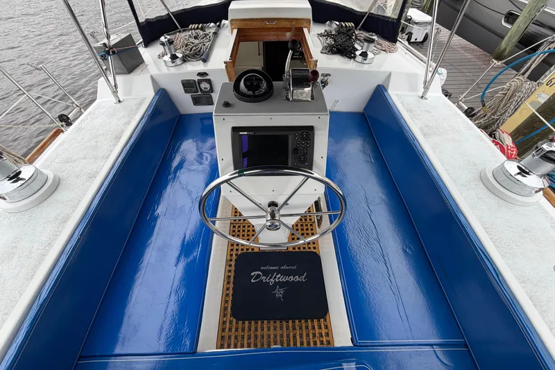 Slide: The Image of Cockpit of 2011 Custom Build 50' Ketch, featuring blue seating and navigation equipment. - 22
