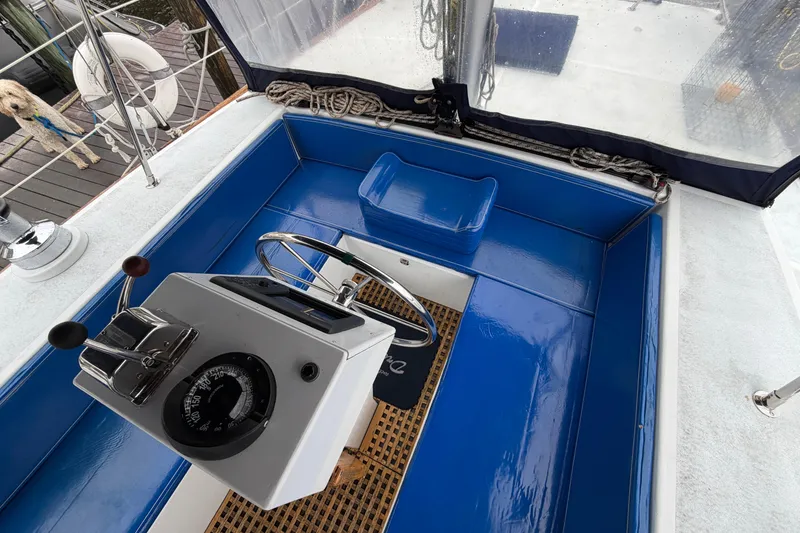 Slide: The Image of Cockpit of 2011 Custom Build 50' Ketch, featuring blue seating and steering console. - 23