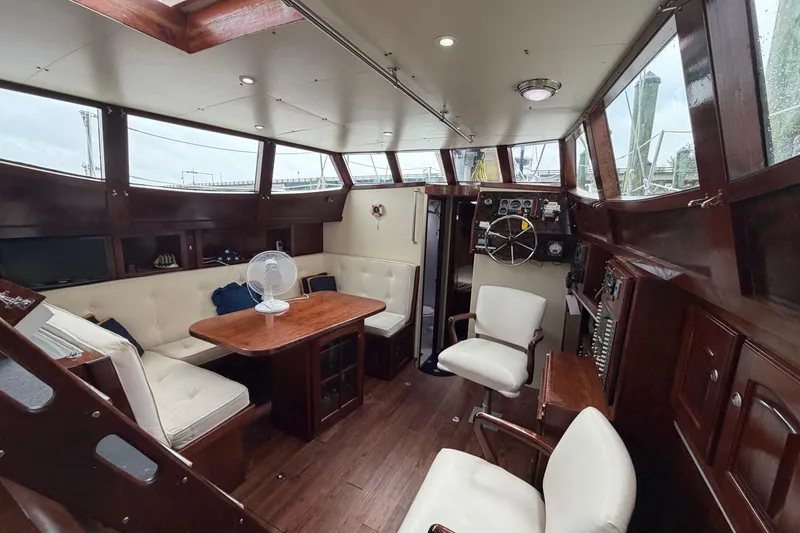 Slide: The Image of Luxurious interior of 2011 Custom Build 50' Ketch, featuring elegant wood finishes and comfortable seating. - 26